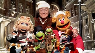 Michael Caine surrounded by Muppets in The Muppet Christmas Carol.