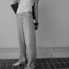 woman wearing jeans and ballet flats