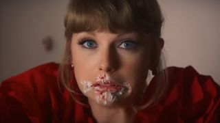 Taylor Swift looking guilty with cake on her face in the I Bet You Think About Me music video.