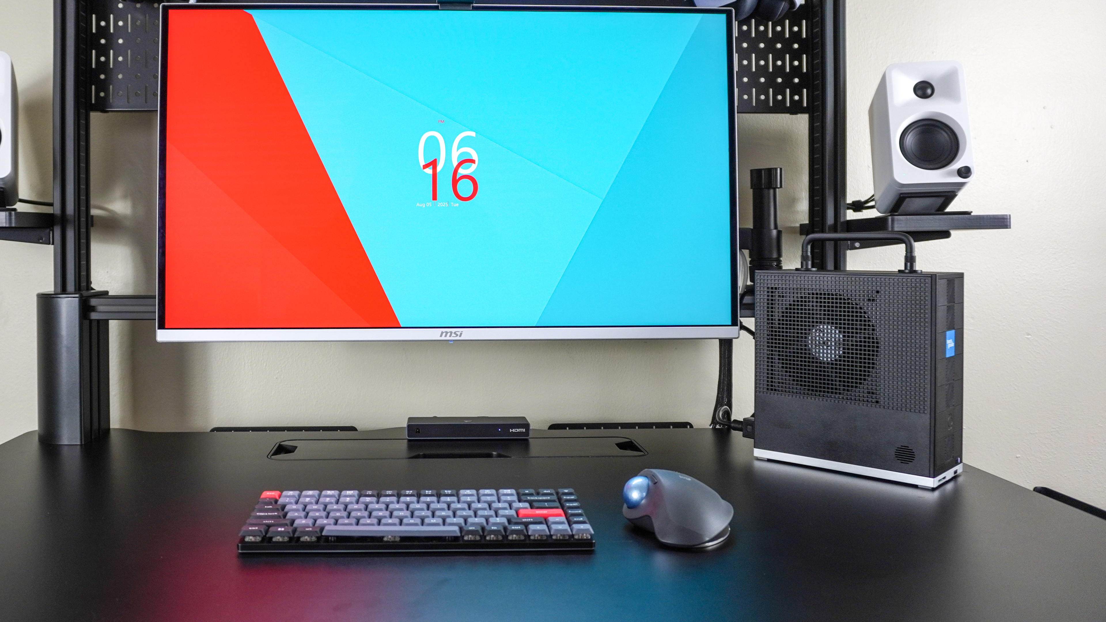 The Framework Desktop powered on and running at a desk
