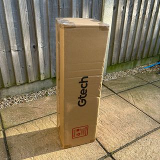 Gtech HeatWave Patio Heater in cardboard box with Gtech logo on patio in garden