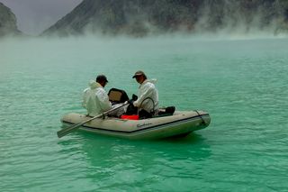 Corentin Caudron and a colleague collect depth measurements at Ijen Crater Lake.