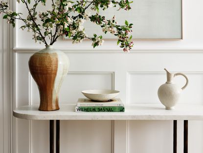 An entryway console table with decor