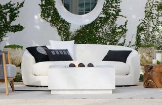 A curved white outdoor sofa
