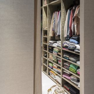 Walk in wardrobe with fitted storage solutions