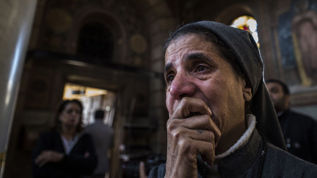 A nun reacts as Egyptian security forces (unseen) inspect the scene of a bomb explosion at the Saint Peter and Saint Paul Coptic Orthodox Church on December 11, 2016, in Cairo&amp;#039;s Abbasiya neig