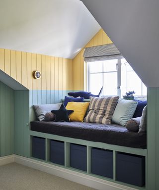 window seat built into dormer window decorated in blue and yello