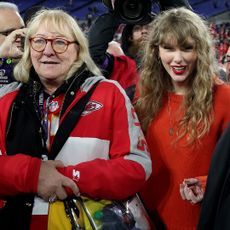 BALTIMORE, MARYLAND - JANUARY 28: Taylor Swift is seen on the field with Donna Kelce, mother of Travis Kelce #87 of the Kansas City Chiefs after the Chiefs' 17-10 victory against the Baltimore Ravens in the AFC Championship Game at M&T Bank Stadium on January 28, 2024 in Baltimore, Maryland. (Photo by Patrick Smith/Getty Images)