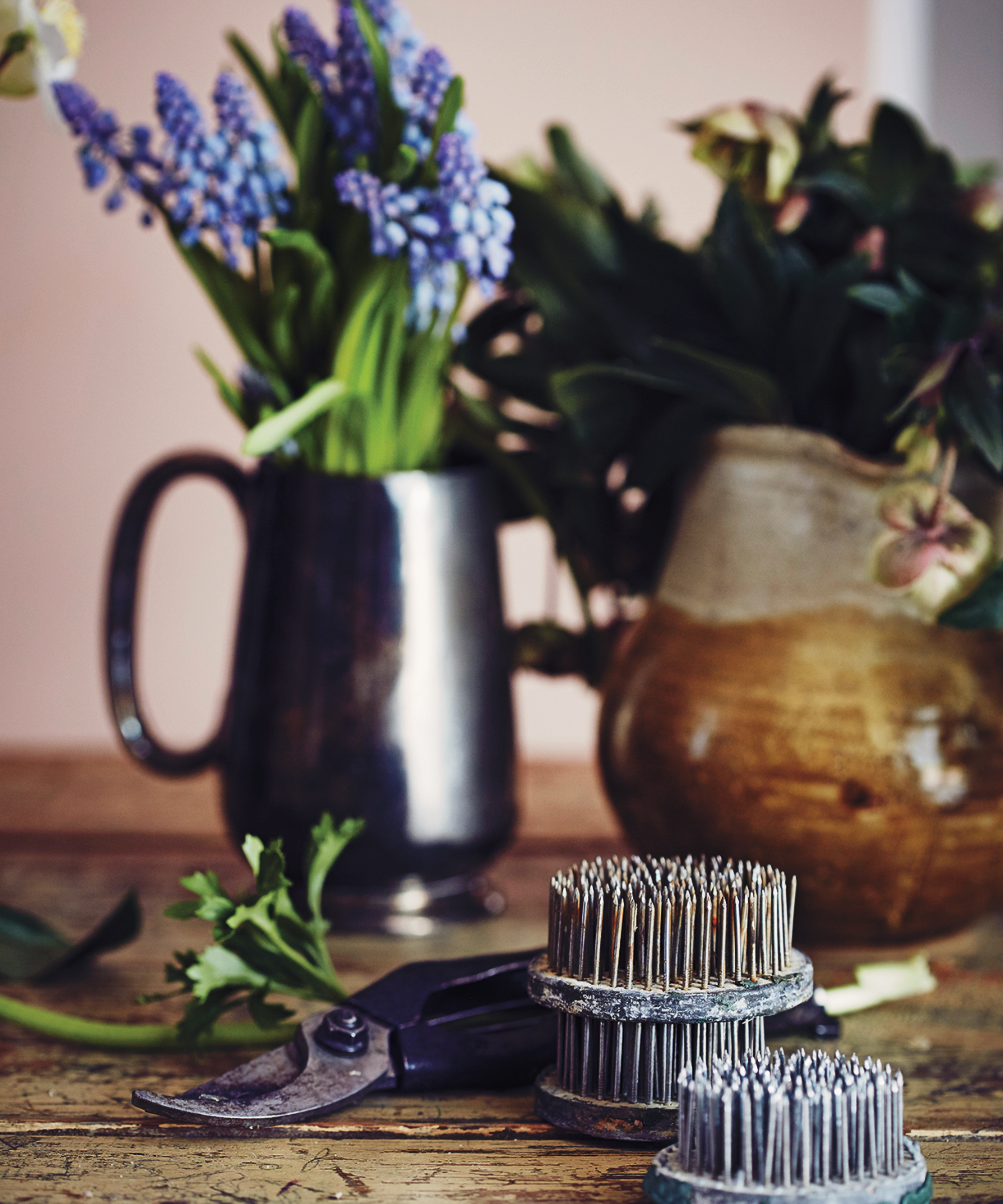 Grape hyacinth in pewter jug with secateurs and florists' tools