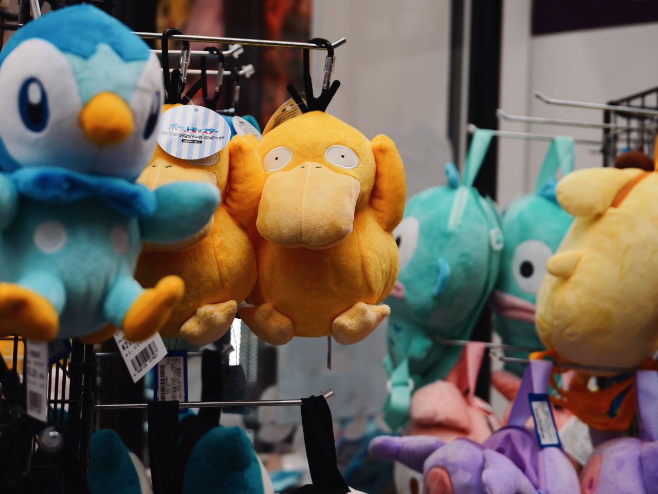 Pok&eacute;mon plush toys hanging on a shop display.