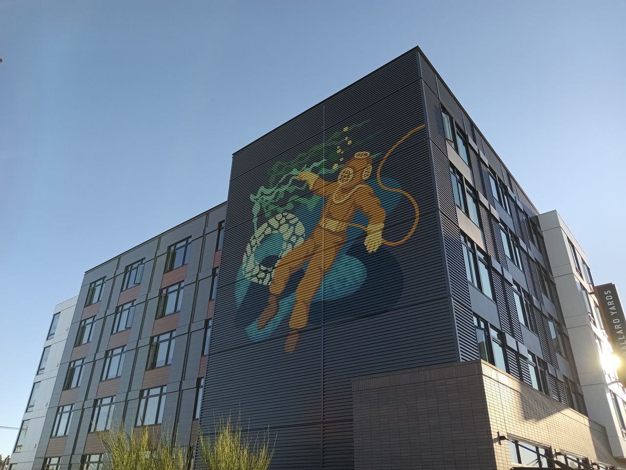 Art on the side of a building depicting a deep sea diver