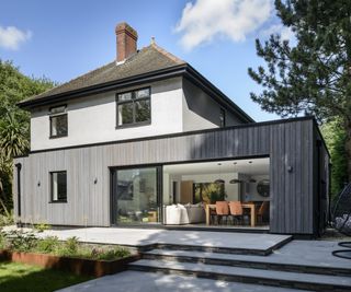 Single-storey rear extension to create a modern family living space that integrates seamlessly into a mature garden setting