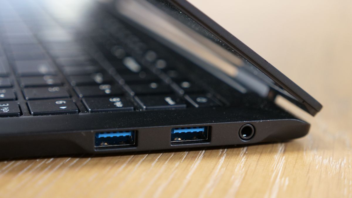 LG Gram Pro 16 2-in-1 (16T90SP) on a wooden table, showing ports on the right side.