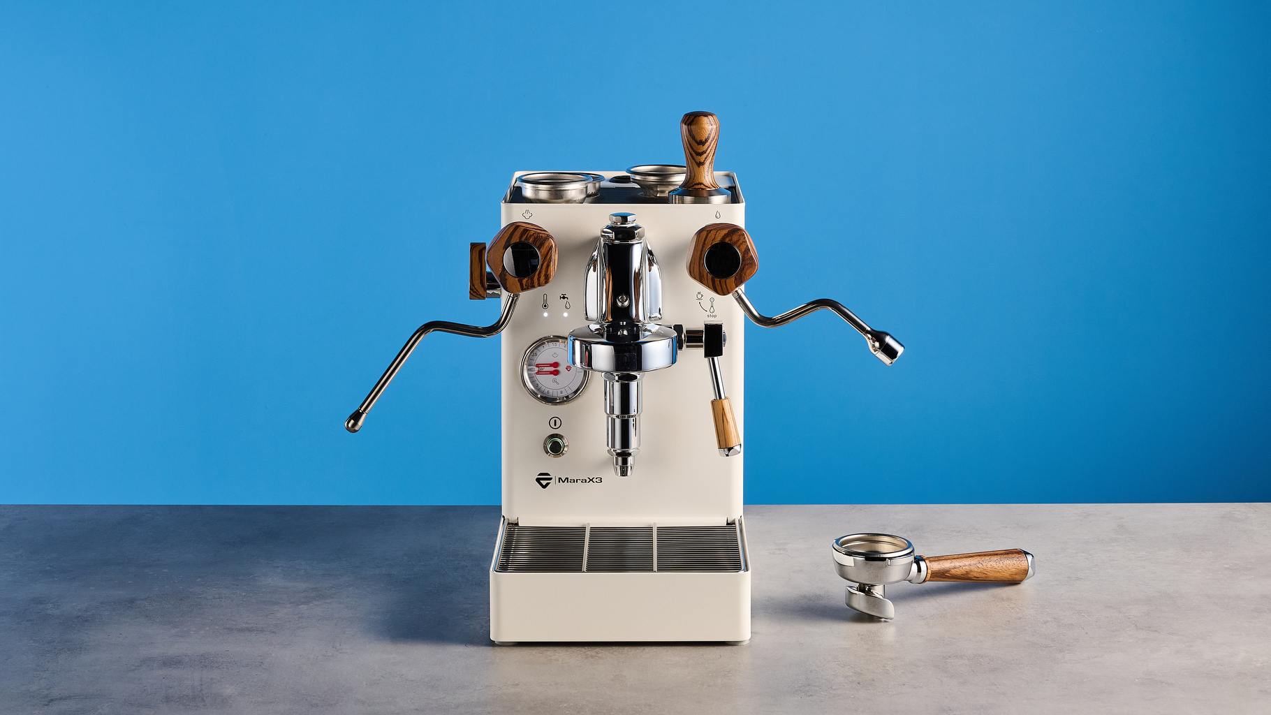 the lelit mara x3 in white and walnut photographed against a blue tom's guide background