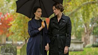 Sian Clifford (as Claire) holds an umbrella over herself and Phoebe Waller-Bridge (as Fleabag) in Fleabag