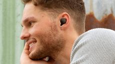 Sennheiser CX Plus True Wireless review: man smiling with headphones in