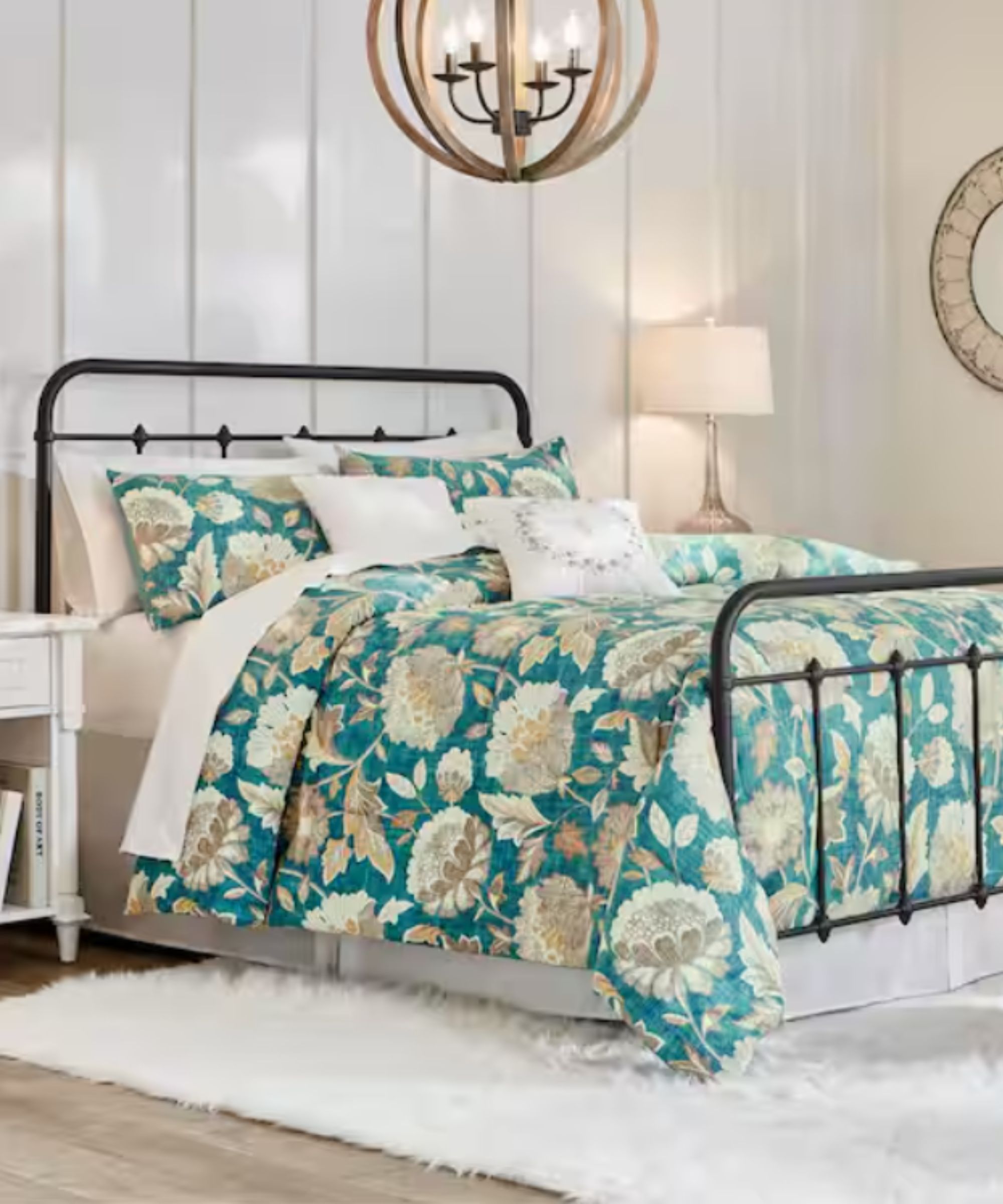 panelled white bedroom with a metal bed frame and teal floral bed linen