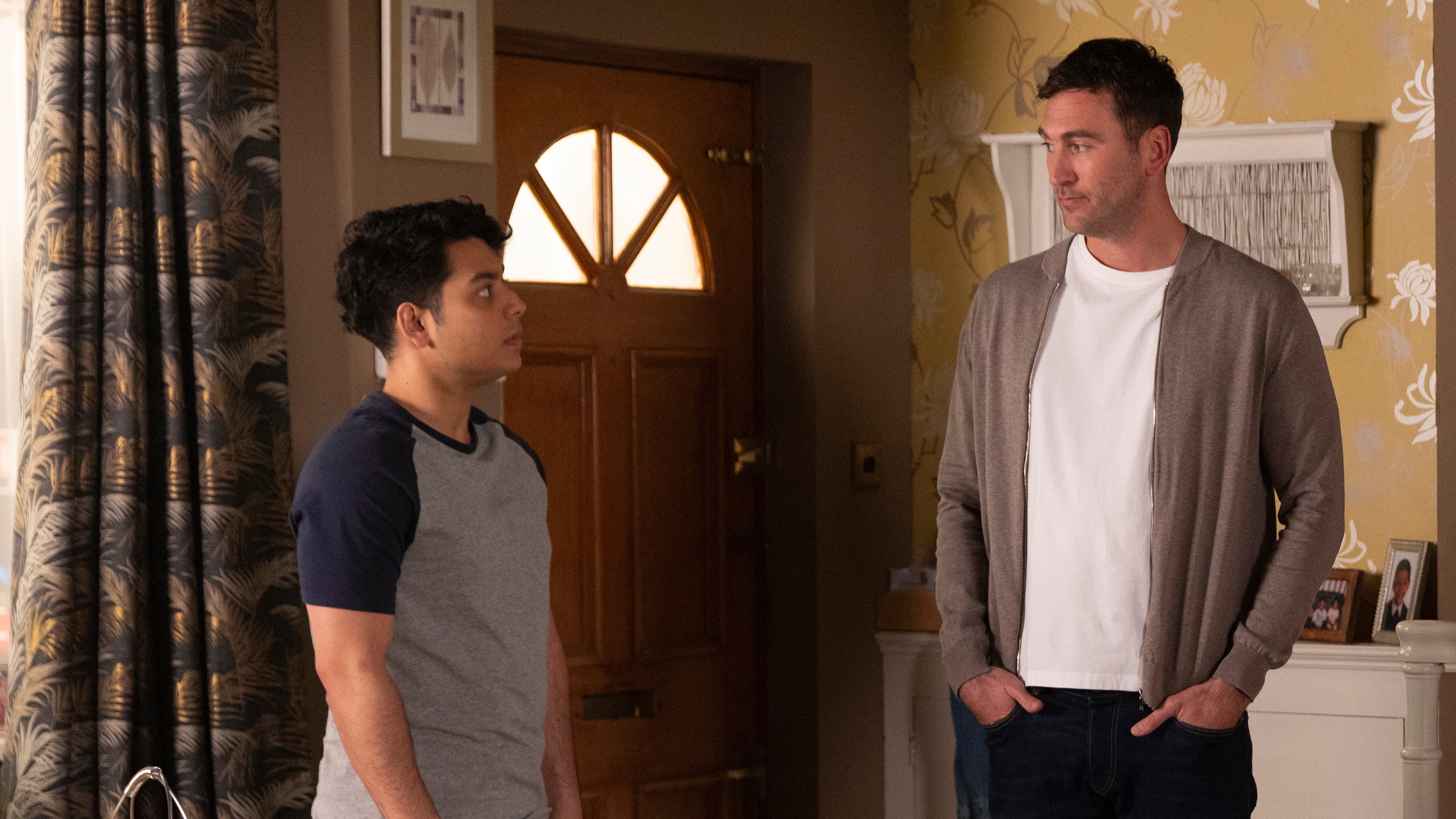 Aadi and Kit look at each other as Kit questions him about the party.
