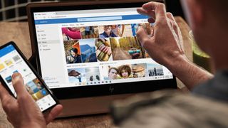 Man using cloud storage on tablet and phone