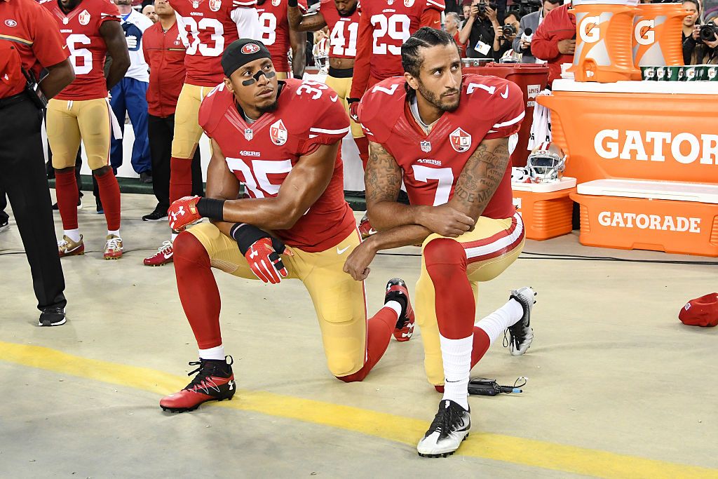 Colin Kaepernick and Eric Reid kneel before a game in 2016.