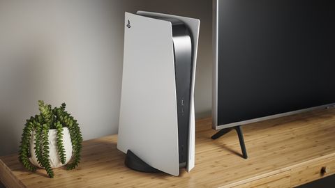 PS5 on a wooden cabinet next to a TV