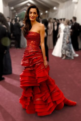 amal clooney wearing a red gown