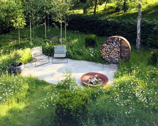 wildflower garden with seats and log store