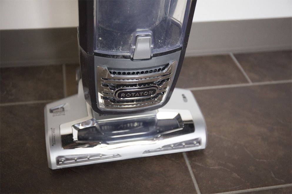 The lights on the base of this Shark vacuum help you see in dark areas.