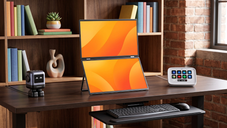 A robot USB-C charger, a dual monitor, Elgato Stream Deck Neo, and a Vivo under-desk keyboard tray on a desk in a modern home office