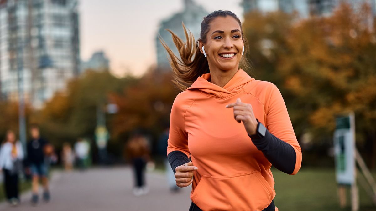 Happy woman running in park