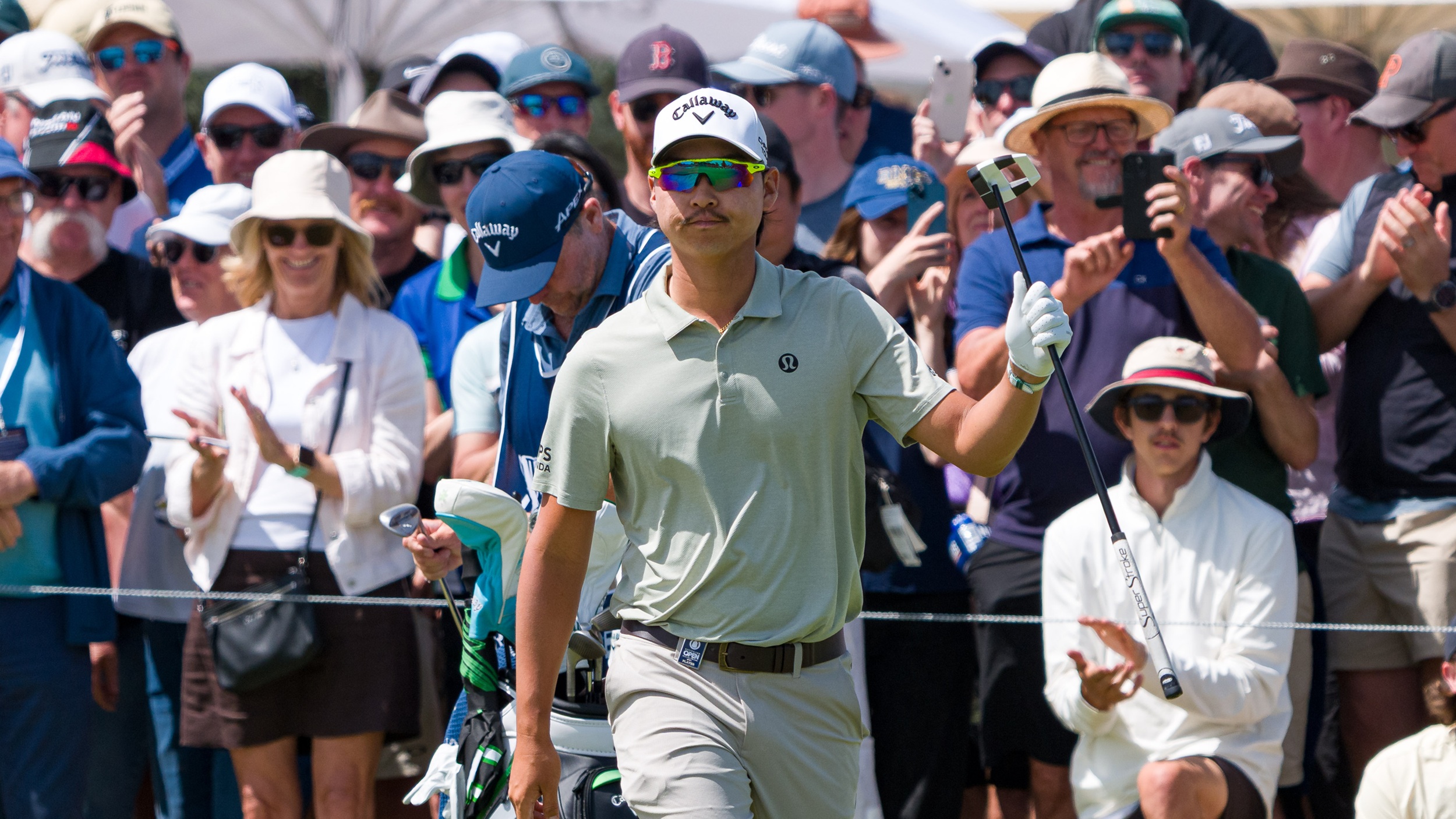 Min Woo Lee waves to the crowd at the 2025 Australian Open at Royal Melbourne