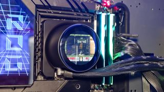 An MSI MPG CoreLiquid P13 all-in-one liquid cooler on a desk and installed onto a test bench for testing.