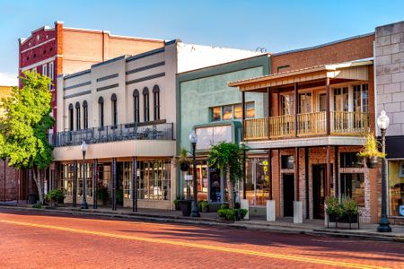 A variety of shops and restaurants in old historic buildings along the idyllic Main Street in Nacogdoches, Texas...