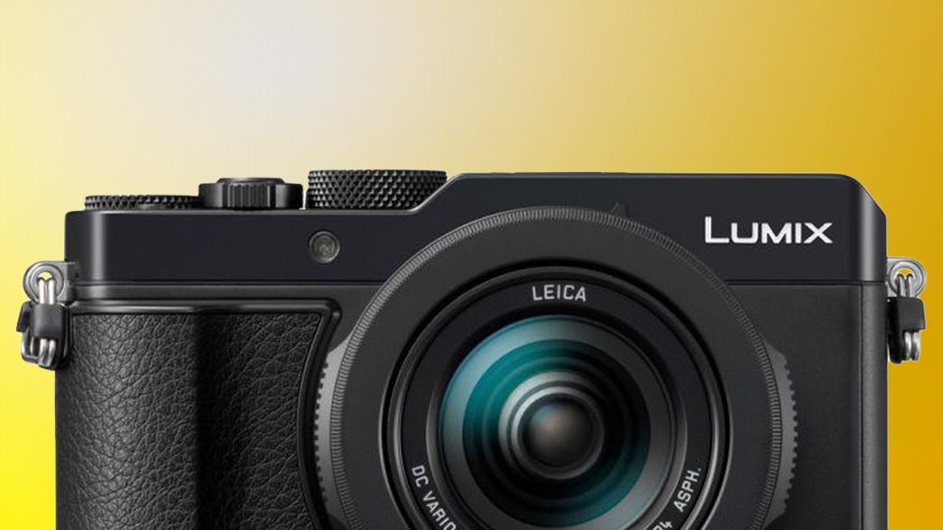 Upper half of the Panasonic Lumix LX100 II on a gradient yellow background