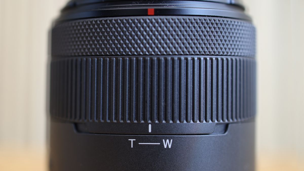 Canon RF 14-30mm f/4-6.3 STM PZ lens on a wooden surface