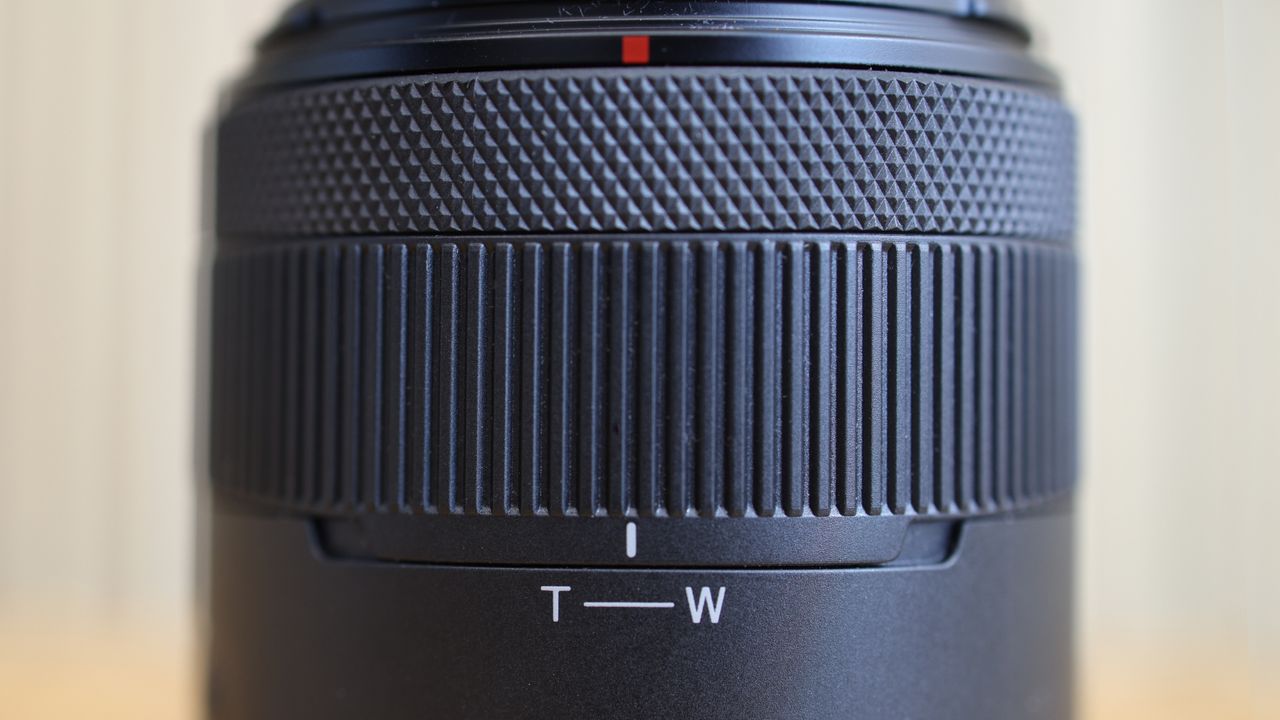Canon RF 14-30mm f/4-6.3 STM PZ lens on a wooden surface