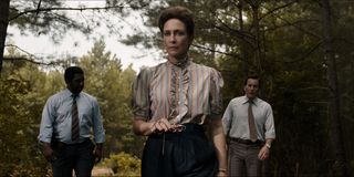 Vera Farmiga as Lorraine Warren with Patrick Wilson as Ed Warren and a police officer in the woods in THe Conjuring The Devil Made ME Do it