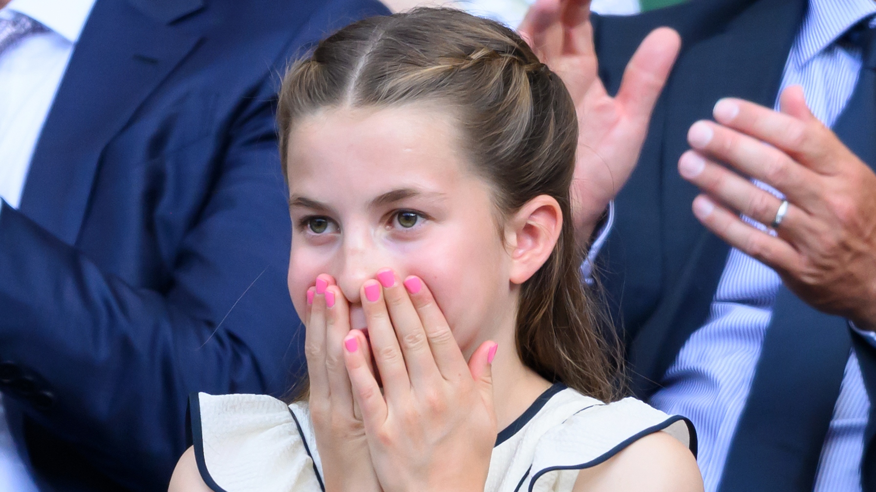 Princess Charlotte of Wales puts her hands to her face as she attends day fourteen of the Wimbledon Tennis Championships at the All England Lawn Tennis and Croquet Club on July 13, 2025