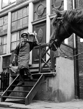 A feces collector picks up toilet waste in Amsterdam in 1953.