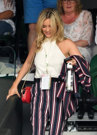 Laura Whitmore wears pinstripe trousers at Wimbledon 2018