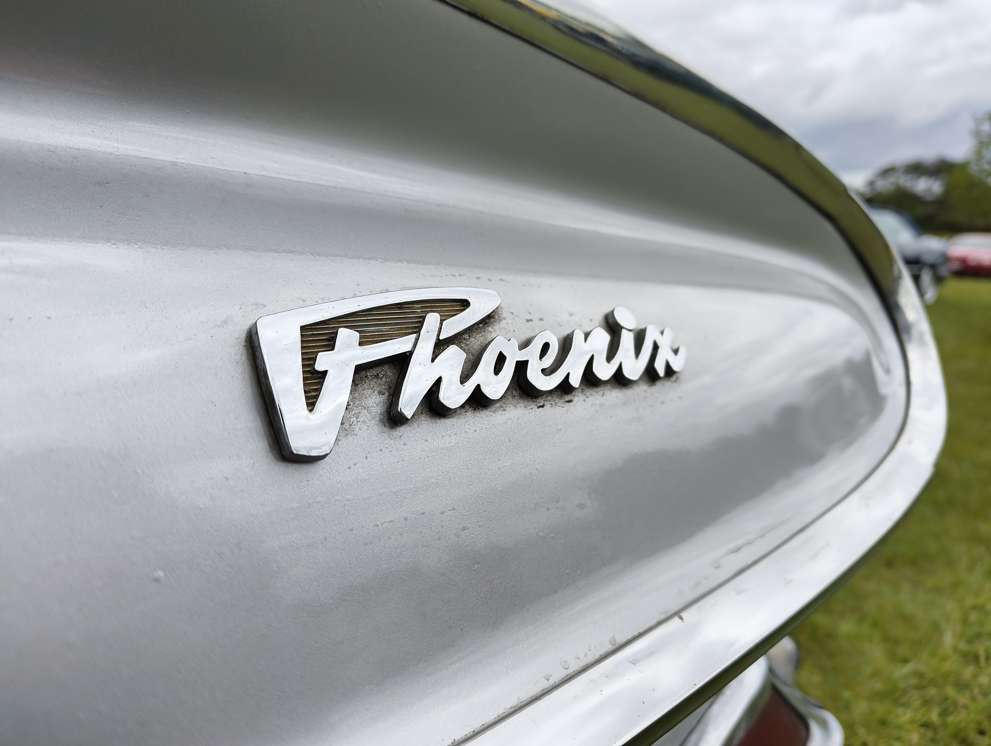 Logo reading Phoenix on the back of a classic vintage car