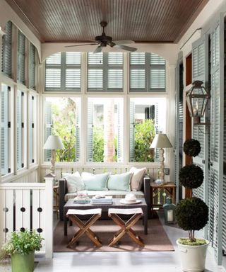 window shutters in a garden sun room with wooden ceiling
