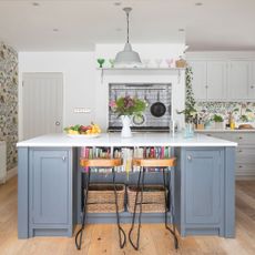 blue kitchen island with floral wallpaper