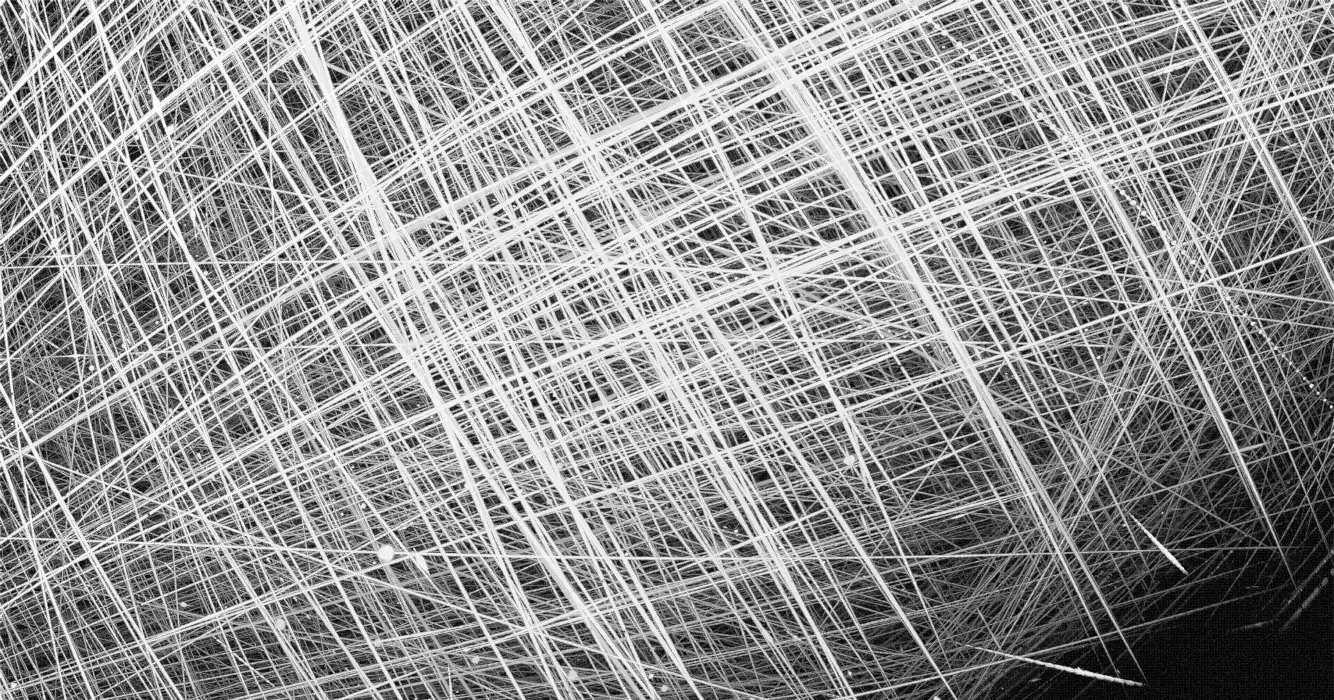 A series of white streaks across a black background