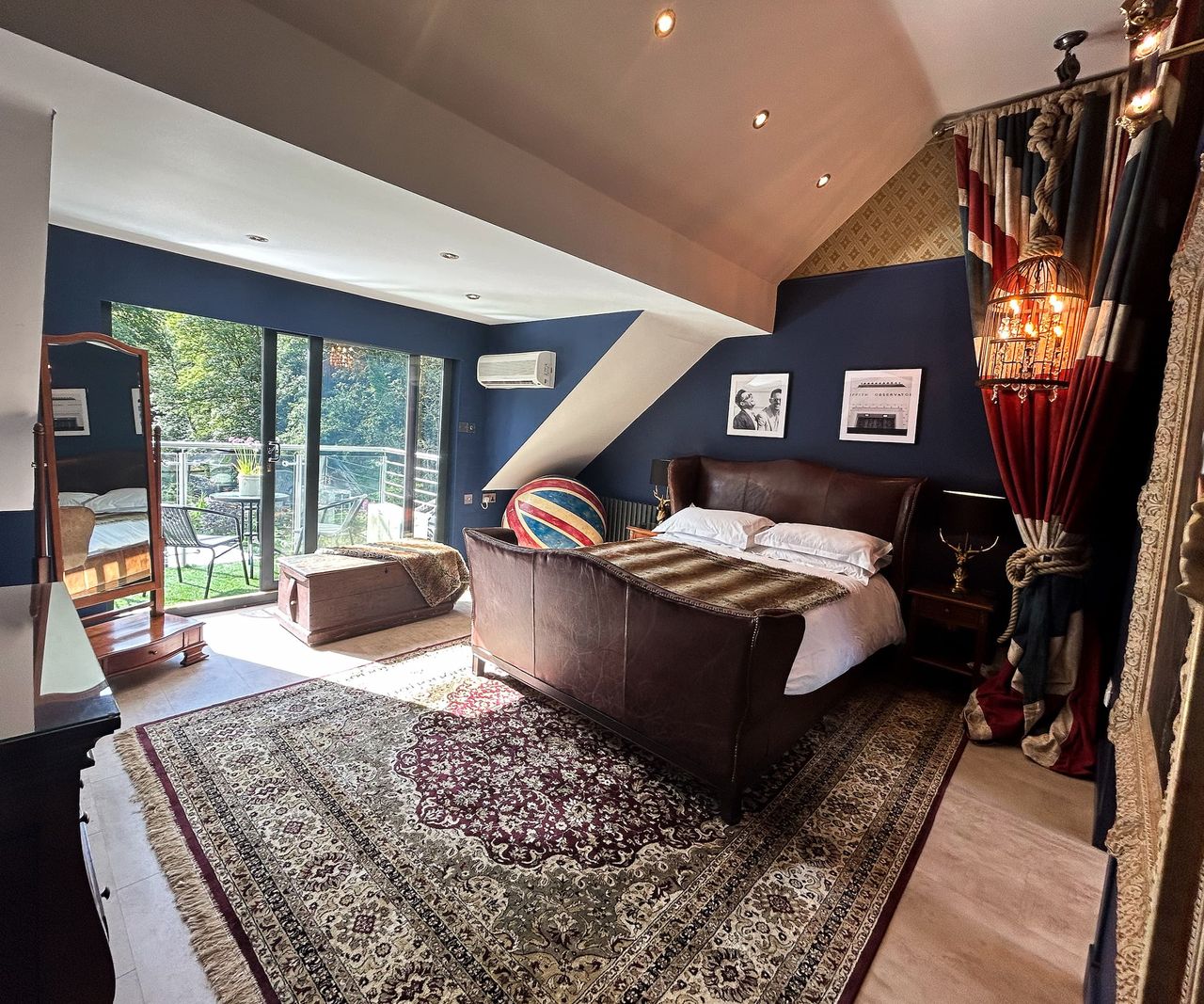 A bedroom with a balcony and slanted roof