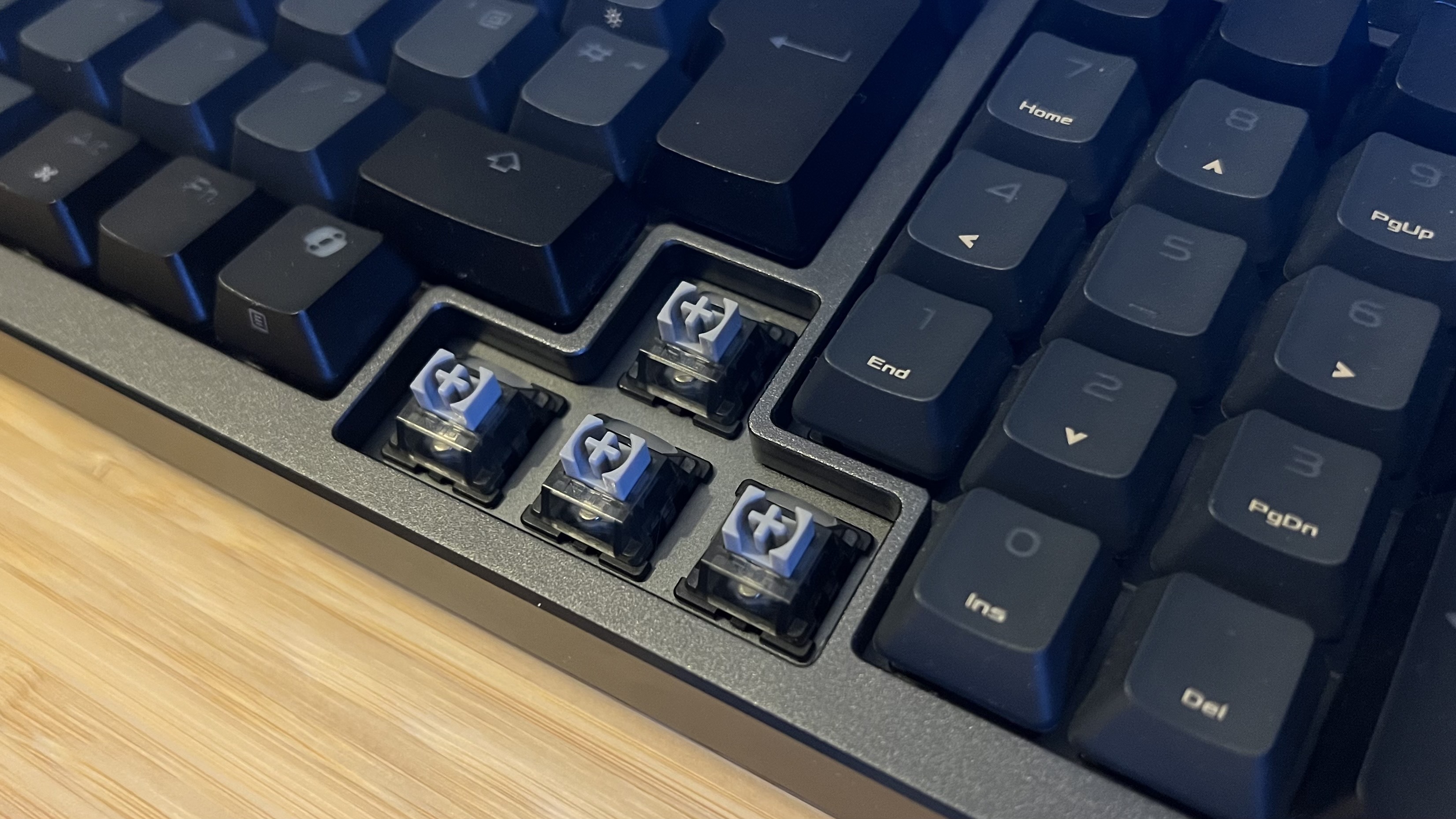 Close up on magnetic switches underneath Asus ROG Azoth 96 HE arrow keys