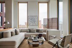 A timeless living room with ceiling high windows