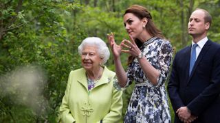 Catherine, Duchess of Cambridge (C) shows Britain's Queen Elizabeth II (L) and Britain's Prince William, Duke of Cambridge, around the 'Back to Nature Garden' garden, that she designed along with Andree Davies and Adam White, during their visit to the 2019 RHS Chelsea Flower Show in London on May 20, 2019.