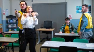 Matty Radcliffe holds a prison officer hostage with a knife as Bobby Crawford and Rob Donovan watch on.