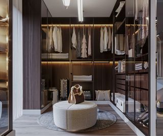 A walk-in closet with an ottoman